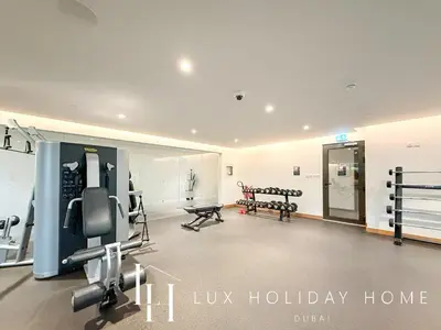 a gym with treadmills and machines in a room at LUX The Business Bay Executive Suite in Dubai