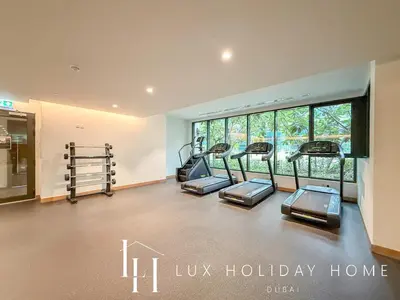 a gym with several treadmills in a room at LUX The Business Bay Executive Suite in Dubai
