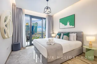 a bedroom with a large bed and a large window at LUX The Business Bay Executive Suite in Dubai