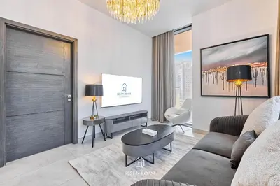 a living room with a couch and a table at Brand New 1B with Burj Khalifa View in Business Bay in Dubai