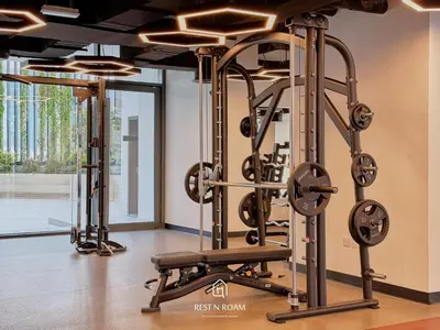 a fitness room with a gym with tread machines at Brand New 1B with Burj Khalifa View in Business Bay in Dubai