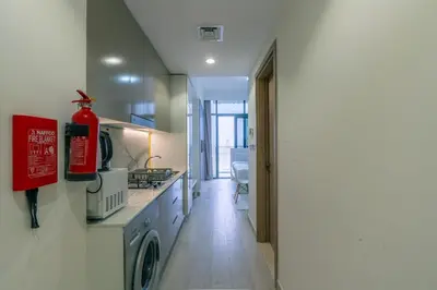 a kitchen with a washer and dryer in a room at Peaceful and Cozy Studio, Burj Khalifa View in Dubai