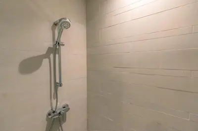 a shower stall with a shower head in a bathroom at Peaceful and Cozy Studio, Burj Khalifa View in Dubai