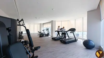 two people exercising in a gym with exercise bikes at Vogue Marina, Condor Marina Star near Ain Dubai and JBR Beach, One Bedroom Apartment with Balcony and City View, Access to all Amenities in Dubai