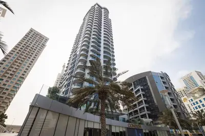 a tall building with a palm tree in front of it at Vogue Marina, Condor Marina Star near Ain Dubai and JBR Beach, One Bedroom Apartment with Balcony and City View, Access to all Amenities in Dubai