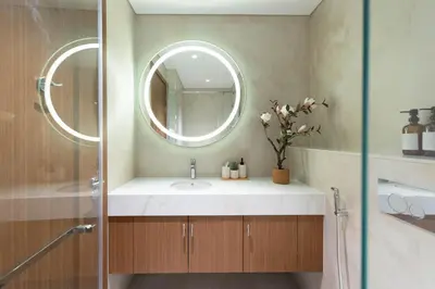 a bathroom with a sink and a mirror at Elegant Studio with Balcony & Pool in Dubai Studio City in Dubai