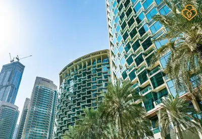 a tall building with palm trees in a city at Seaview 3 BR Burj Vista Connected to Dubai Mall in Dubai