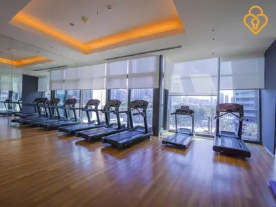 a gym with a row of treadmills in a building at Seaview 3 BR Burj Vista Connected to Dubai Mall in Dubai