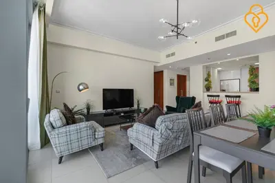 a living room with a couch and chairs and a table at Seaview 3 BR Burj Vista Connected to Dubai Mall in Dubai