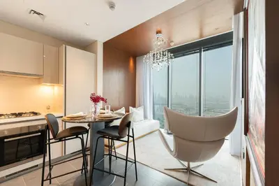 a kitchen and dining room with a table and chairs at Luxury 1BR Retreat near DIFC & Downtown Dubai in Dubai