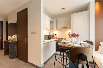 a kitchen and a dining room with a table and chairs at Luxury 1BR Retreat near DIFC & Downtown Dubai in Dubai