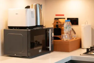 a coffee maker on top of a microwave on a counter at Luxury 1BR Retreat near DIFC & Downtown Dubai in Dubai