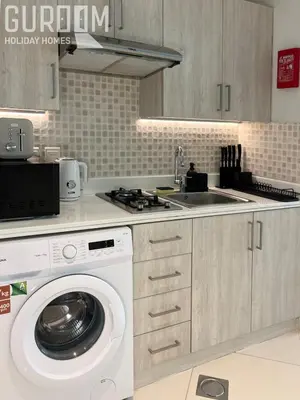 a kitchen with a washing machine and a sink at Great Cozy Studio on Palm Jumeirah in Dubai