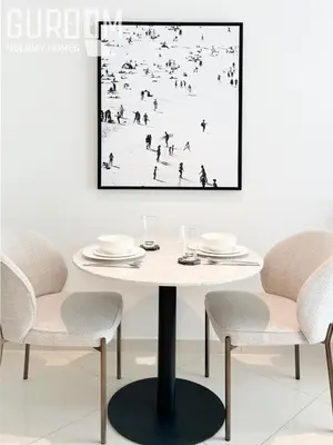 a dining room with a white table and chairs at Great Cozy Studio on Palm Jumeirah in Dubai