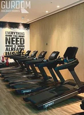 a row of tread machines in a gym at Great Cozy Studio on Palm Jumeirah in Dubai