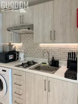 a kitchen with a sink and a stove top oven at Great Cozy Studio on Palm Jumeirah in Dubai