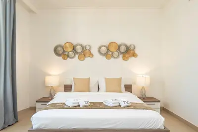 a bedroom with a bed with two towels at PVH - Creek Residences South T3 - Harbourfront 2BR in Dubai