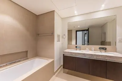 a bathroom with a tub and a large mirror at PVH - Creek Residences South T3 - Harbourfront 2BR in Dubai