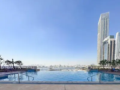 a large swimming pool in a city with tall buildings at PVH - Creek Residences South T3 - Harbourfront 2BR in Dubai