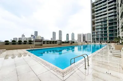 a large swimming pool on the roof of a building at PVH - Pristine 1BR Minutes to Circle Mall - Binghatti Amber in Dubai