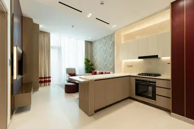 a kitchen with a stove and a counter top at Modern 1BR Apartment with Private Pool in JVC in Dubai