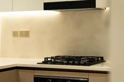 a stove top oven in a kitchen next to a wall at Elegant Apartment with Balcony Pool & Parking in Dubai