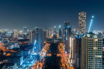 a city lit up at night with buildings at Elegant Apartment with Balcony Pool & Parking in Dubai