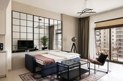 a living room with a couch and a tv at Designer 1BR with Skyline View in MJL - Near Iconic Burj Al in Dubai