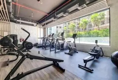 a gym with several exercise bikes in a room at Chic Studio Living Elysee III by Pantheon in Dubai