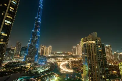 a view of a city at night at 4BR Penthouse Feel Featuring Stunning Burj And Fountain View in Dubai