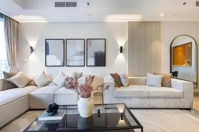 a living room with a couch and a table at 4BR Penthouse Feel Featuring Stunning Burj And Fountain View in Dubai