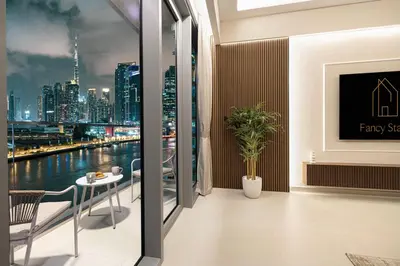 a room with a view of a city skyline at Canal Stays in Dubai
