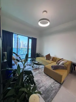 a living room with a couch and a large window at High-Floor 1BR Escape - The Bay Rooftop Pool in Dubai