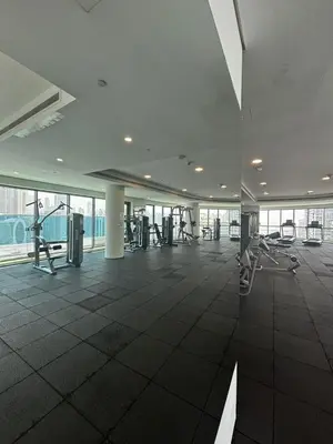 an empty gym with exercise equipment in a building at High-Floor 1BR Escape - The Bay Rooftop Pool in Dubai