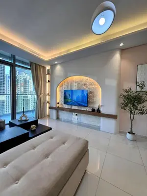 a living room with a couch and a tv at Luxury 2BR, Burj Khalifa View, Fully equipped, Top Amenities in Dubai