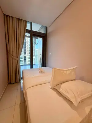 a bedroom with two beds and a large window at Luxury 2BR, Burj Khalifa View, Fully equipped, Top Amenities in Dubai