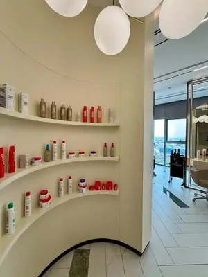 a room with shelves of products on a wall at Luxury 2BR, Burj Khalifa View, Fully equipped, Top Amenities in Dubai