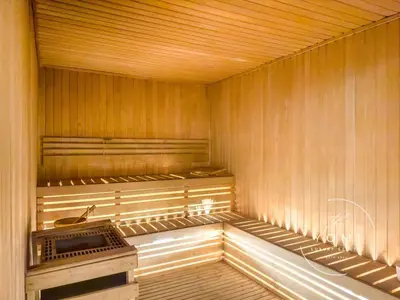 an empty sauna with a stove in the middle at Luxury 2BR, Burj Khalifa View, Fully equipped, Top Amenities in Dubai