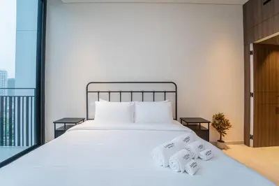 a bedroom with a bed with two towels on it at Sleek New 1 Bed with Padel Court in Arjan in Dubai