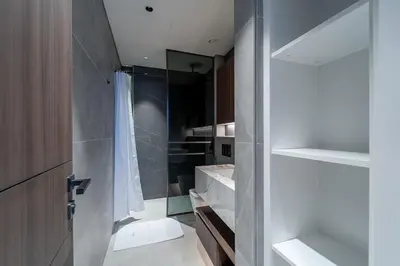 a bathroom with a shower and a toilet and a sink at Sleek New 1 Bed with Padel Court in Arjan in Dubai