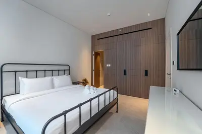 a bedroom with a large bed and a sliding door at Sleek New 1 Bed with Padel Court in Arjan in Dubai