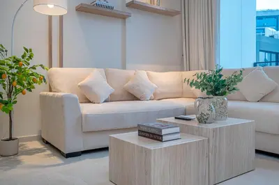 a living room with a couch and a coffee table at Sleek New 1 Bed with Padel Court in Arjan in Dubai