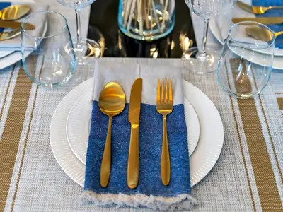 a table with a white plate with fork and knife at NEW Noma Majestine Hotel Style Apt Business Bay in Dubai