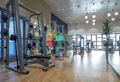 a gym with several tread machines in a room at Marina Sea View Room Dubai in Dubai