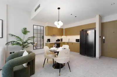 a kitchen and dining room with a table and chairs at Maison Privee - Tranquil Living with Golf Course Vws in Dubai Hills in Dubai