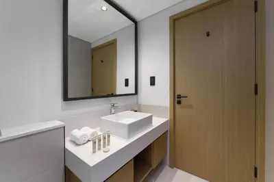 a bathroom with a sink and a mirror at Maison Privee - Tranquil Living with Golf Course Vws in Dubai Hills in Dubai