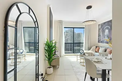 a living room with a table and a couch at HAVN - High Floor 1 bedroom in JLT in Dubai
