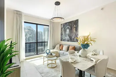 a living room with a table and a couch at HAVN - High Floor 1 bedroom in JLT in Dubai