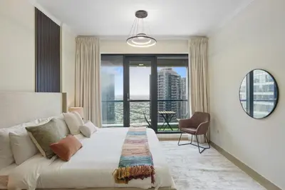 a bedroom with a large bed and a large window at HAVN - High Floor 1 bedroom in JLT in Dubai