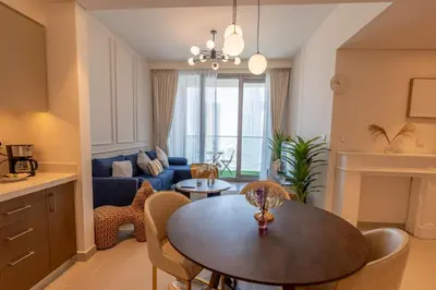 a living room with a table and a couch at HAVN - High Floor 2 bedroom in Downtown in Dubai